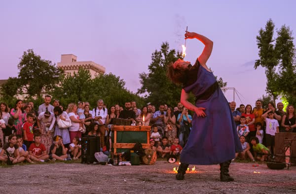 Performer inarcata con la torcia accesa al tramonto, Atella Sound Circus 2023
